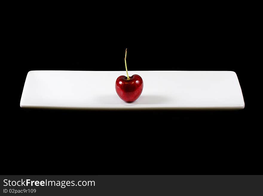 Heart shape cherry against black background. Heart shape cherry against black background