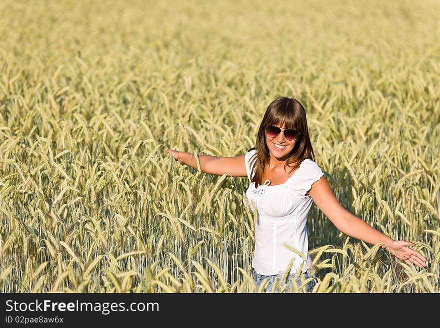 Happy young woman in corn field enjoy sunset