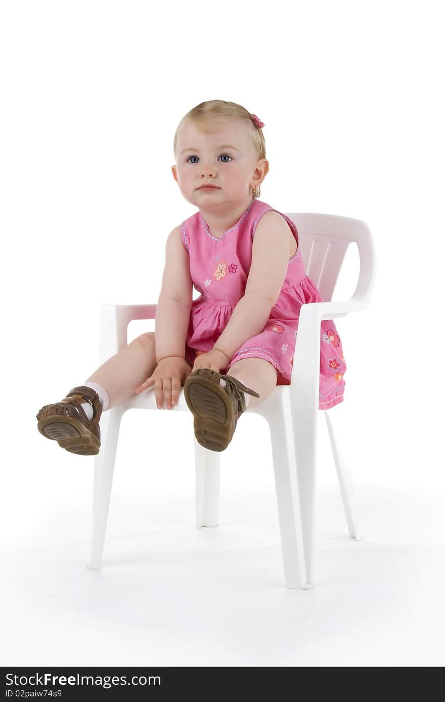 Toddler on stool on white background.