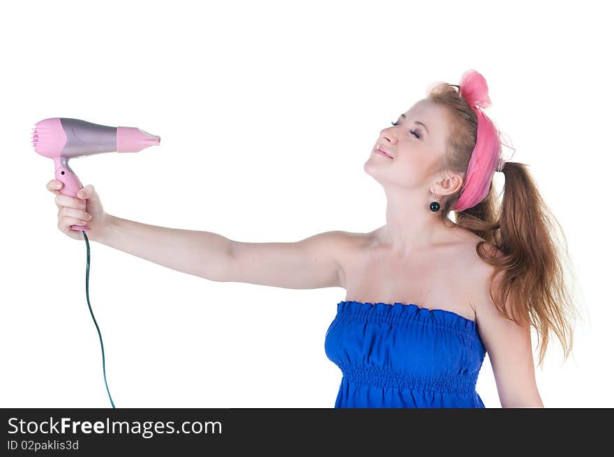 Red-haired girl with the hair dryer. Isolated over white .