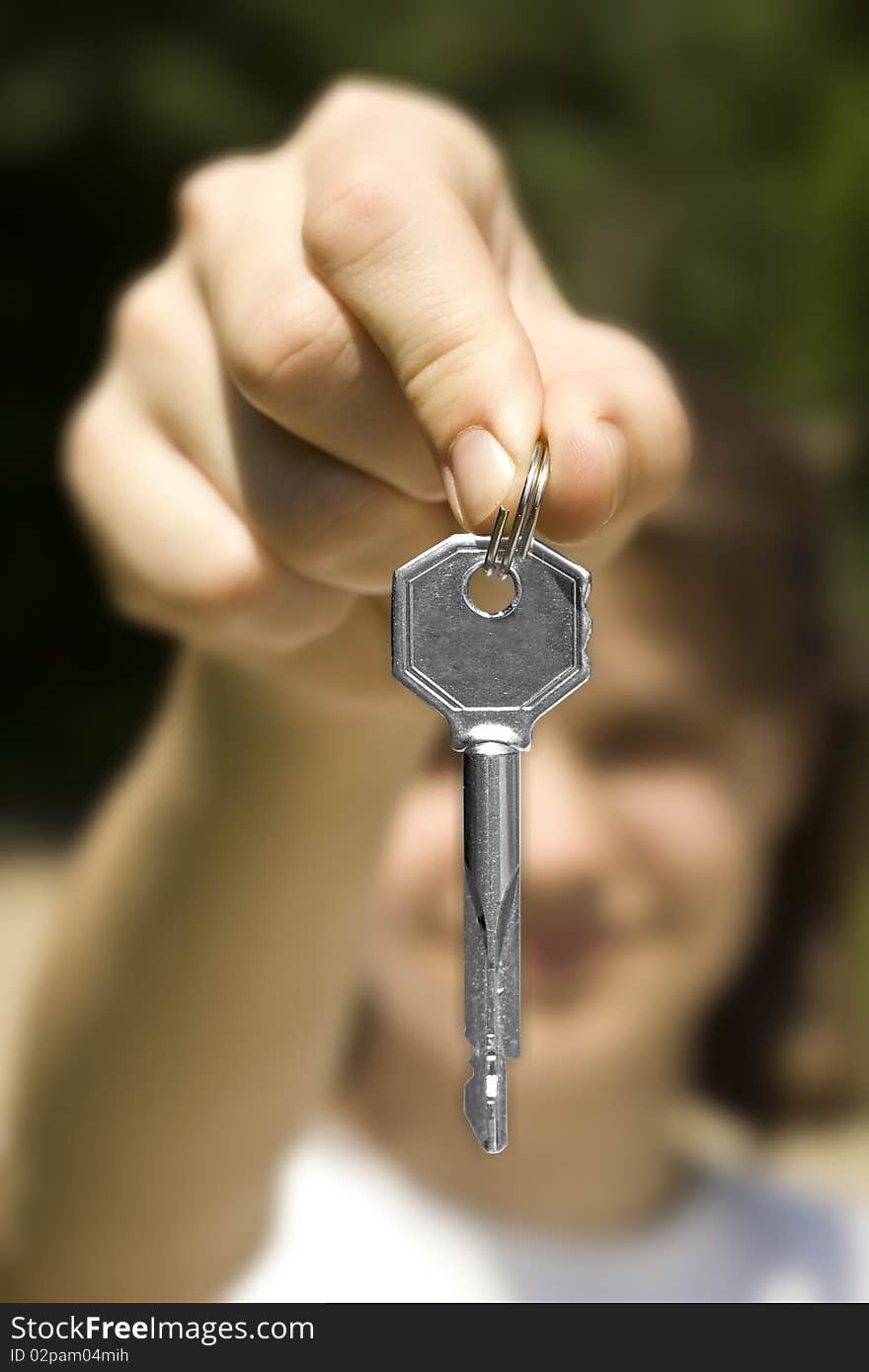 And holds a key (key in focus)