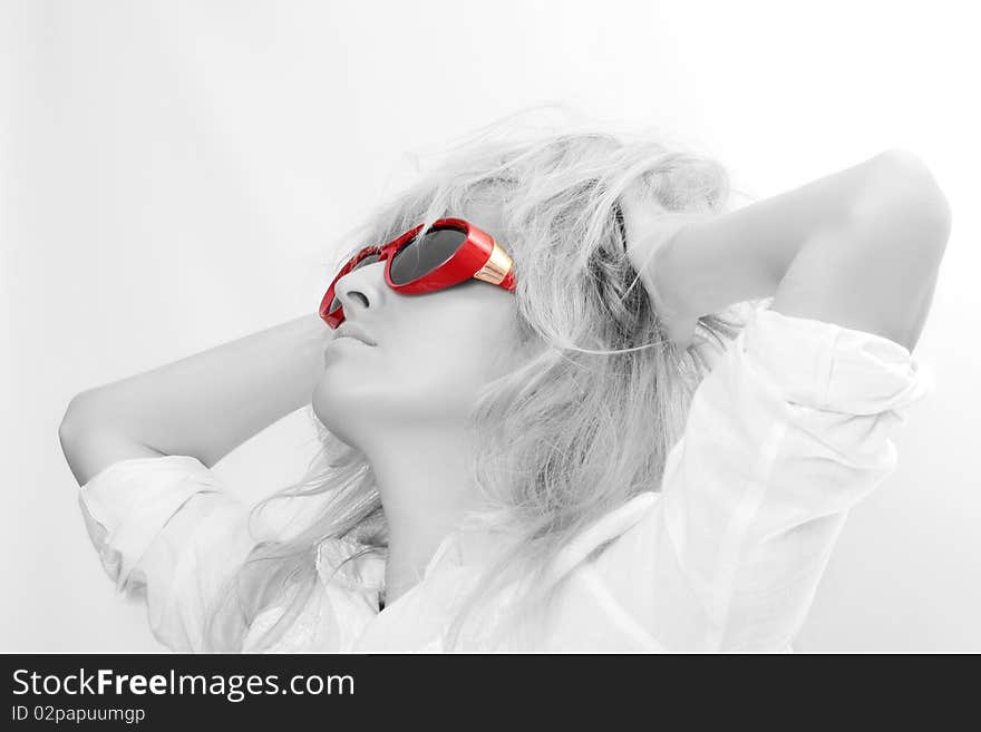 The beautiful woman. Disheveled hair. Red glasses