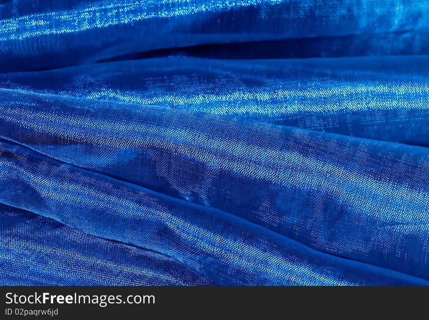 Close up of a bright blue material with reflections