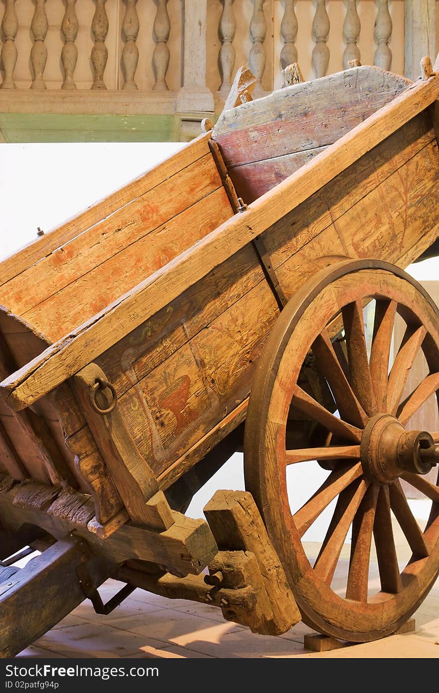 Old wooden cart for transport agricultural products - whell of wood and iron with brake stopper