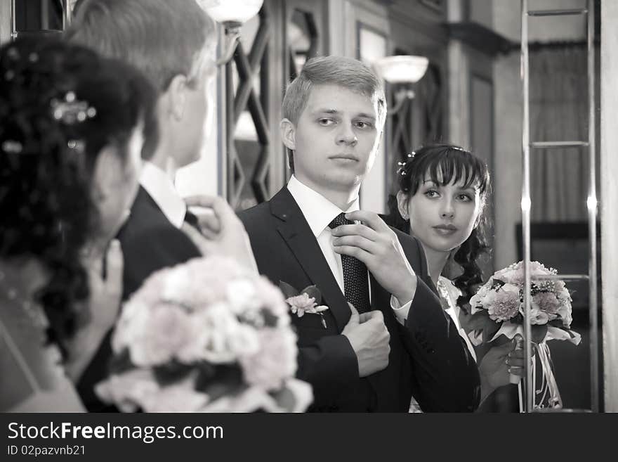 The bride and groom before the mirror. The bride and groom before the mirror