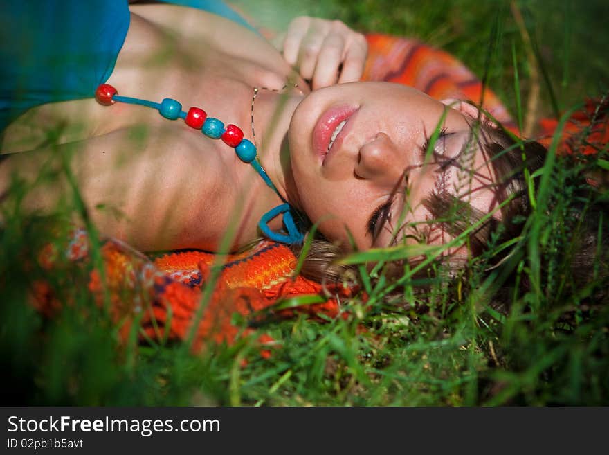 Portrait of attractive girls on the nature of the grass