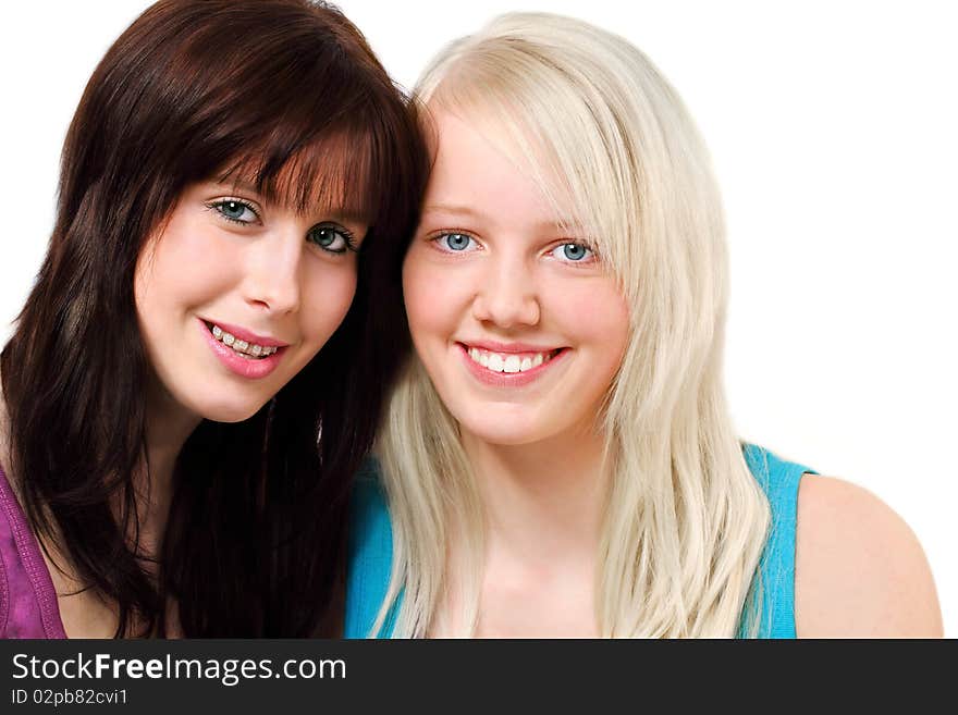 Two cute girls,  one brunette and one blond, smiling for a portrait, isolated on white. Two cute girls,  one brunette and one blond, smiling for a portrait, isolated on white