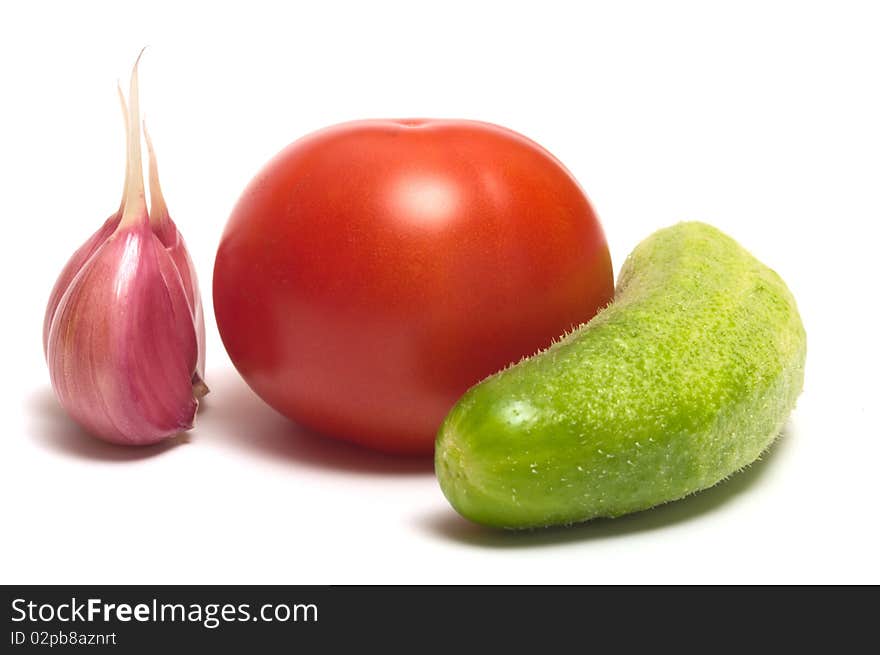 Garlic, tomato and cucumber closeup on a white background. Garlic, tomato and cucumber closeup on a white background.