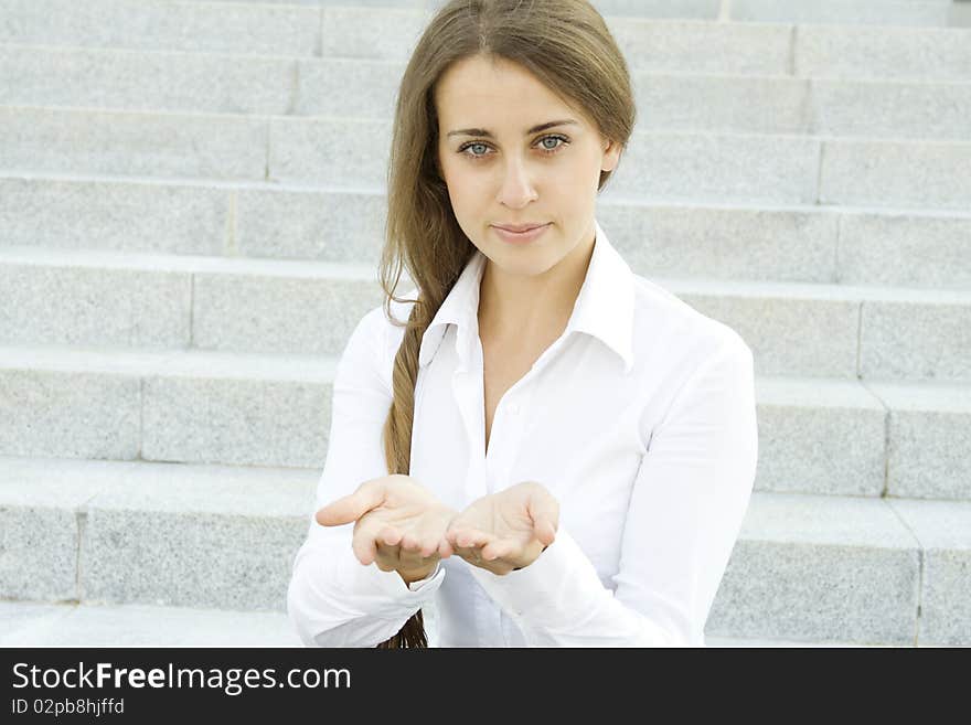 Close-up of a young woman gesturing. Outdoors