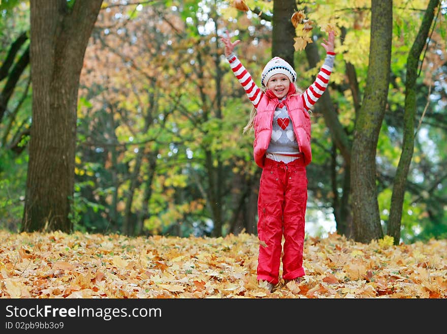 Young happy girl playing in autumn park. Young happy girl playing in autumn park