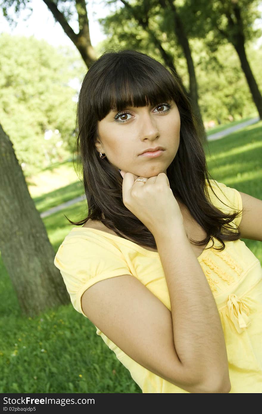 Young woman pensive outdoors in the park. Young woman pensive outdoors in the park