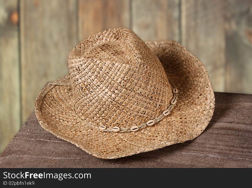 Detailed image of a cowboy hat set against a wood fence,. Detailed image of a cowboy hat set against a wood fence,