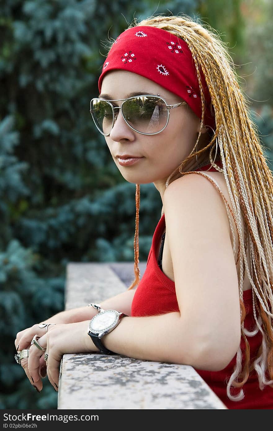 Rapper girl in red posing outdoors