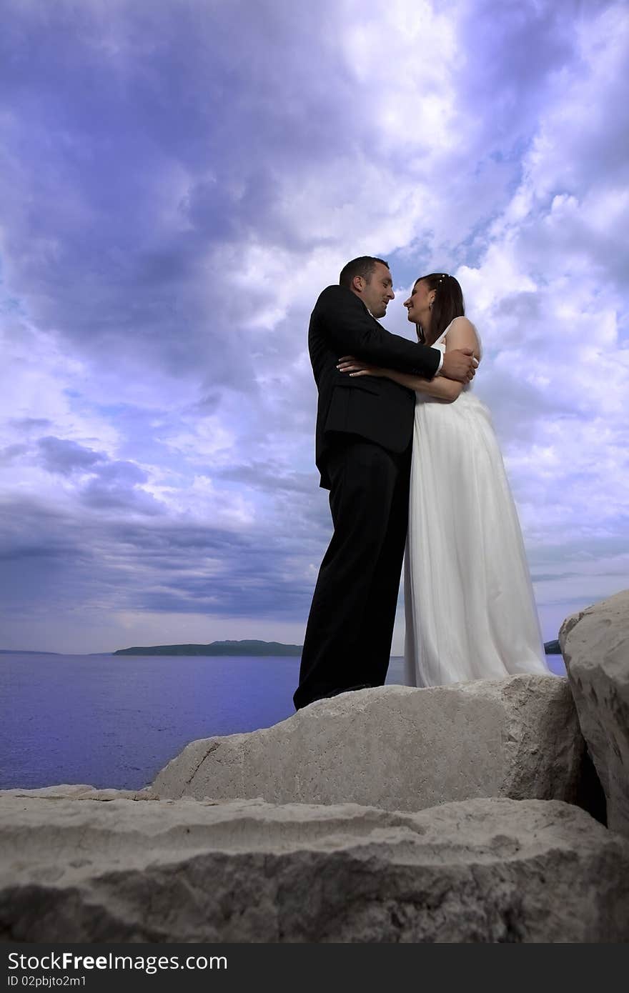 Wedding young nice couple by the sea, on their wedding day. Wedding young nice couple by the sea, on their wedding day