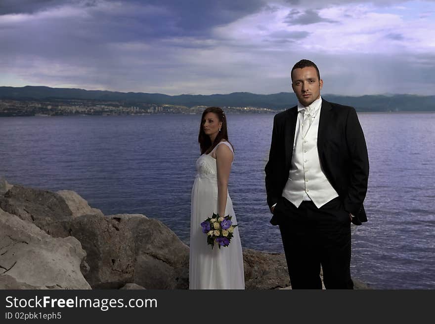 Wedding young nice couple by the sea, on their wedding day. Wedding young nice couple by the sea, on their wedding day