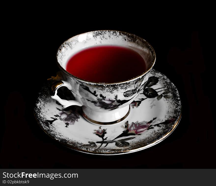 Cup of red tea in black background