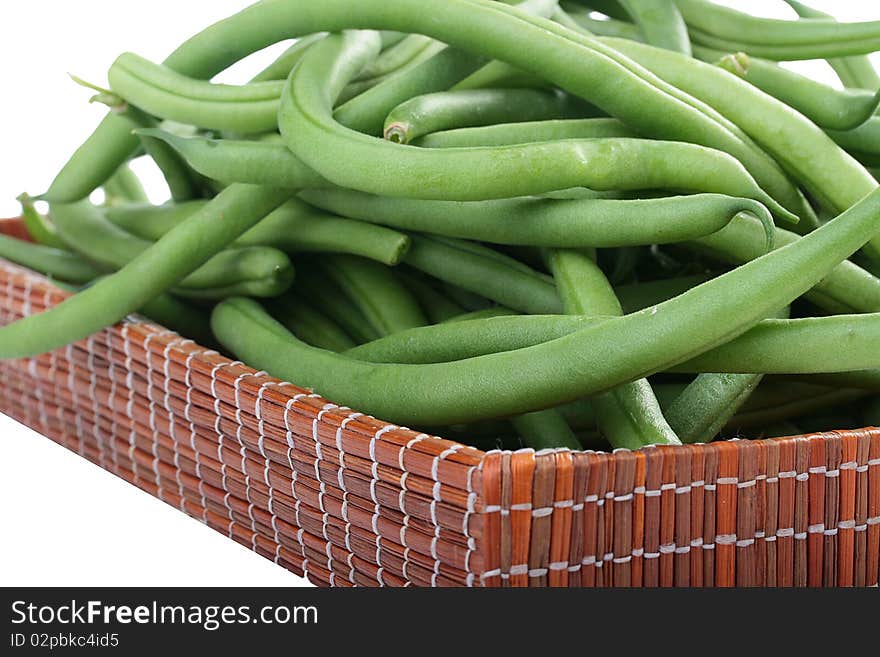 Young green French string bean in pods on a white background. Young green French string bean in pods on a white background.