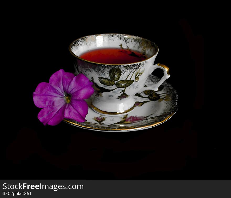 Cup of red tea in black background