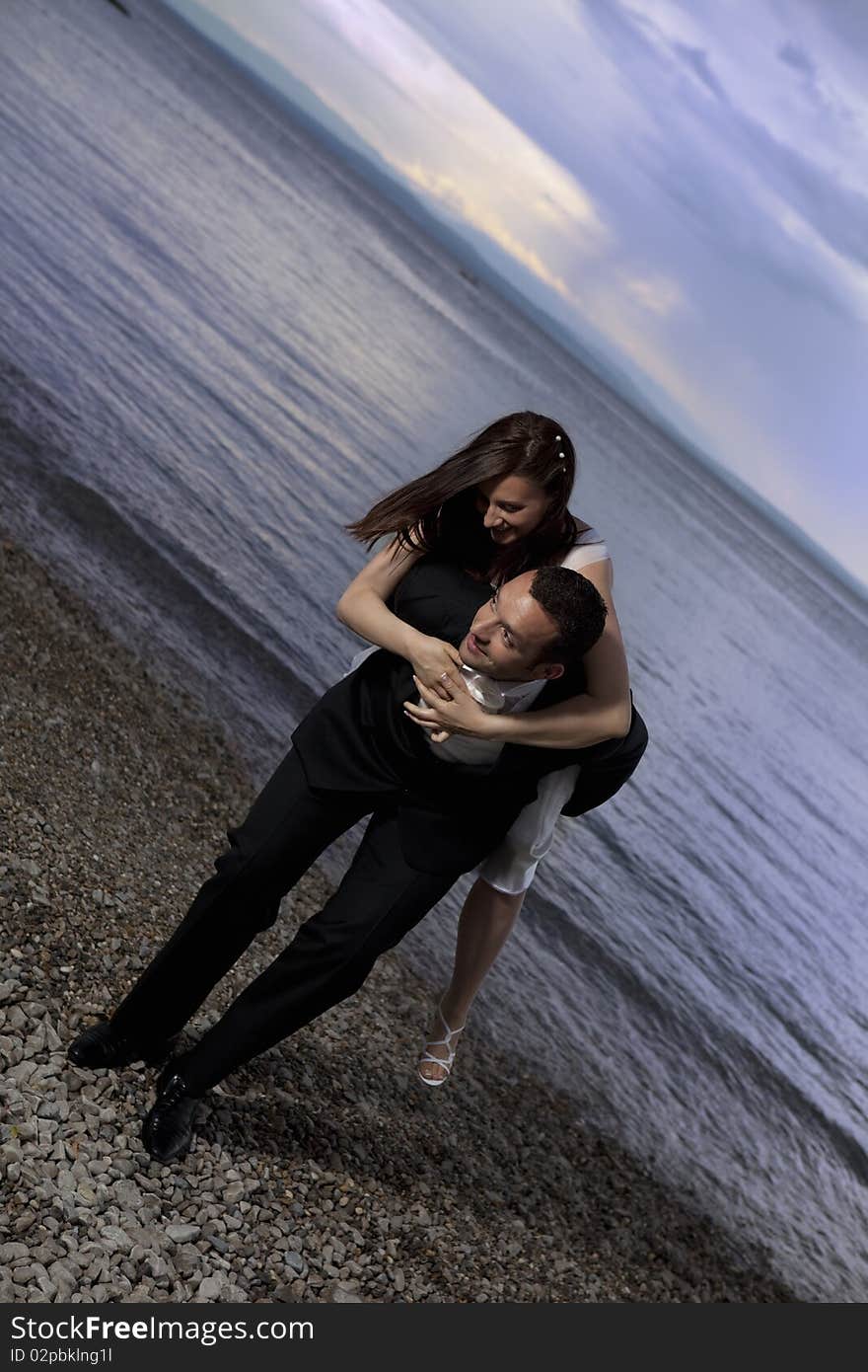 Wedding couple by the sea, dramatic sky