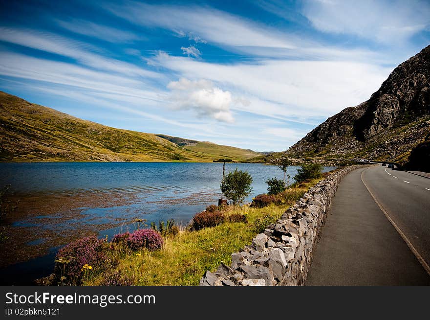 Panoramic landscape view of lake mountains and blue sky. Panoramic landscape view of lake mountains and blue sky