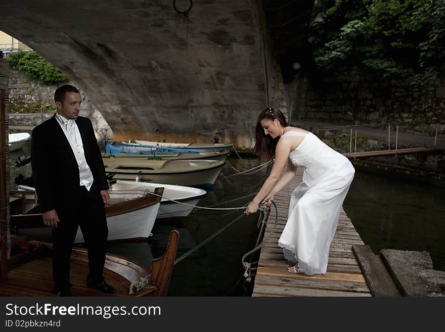 Wedding couple on vessel in the harbour