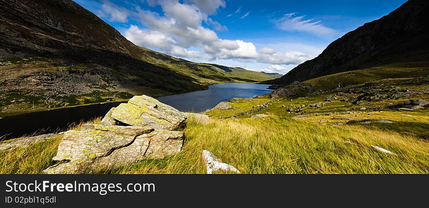 Panoramic landscape view of lake mountains and clear blue sky. Panoramic landscape view of lake mountains and clear blue sky