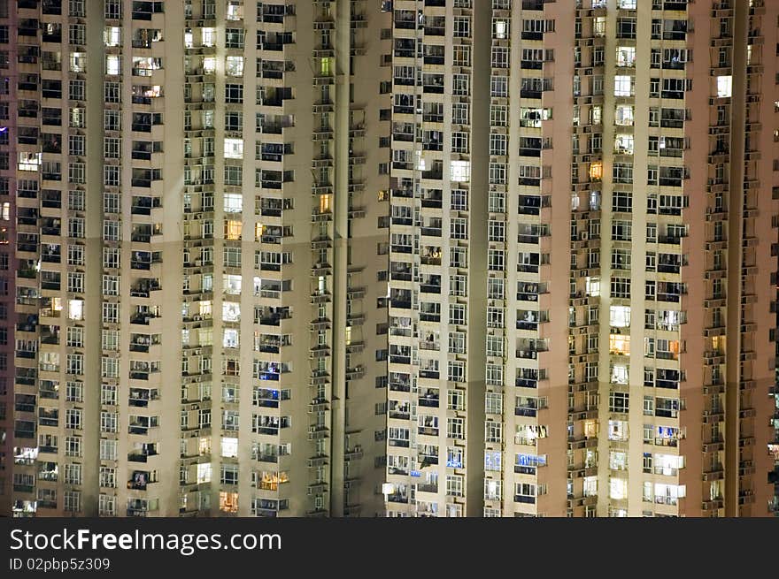 Residential buildings by night, tall skyscrapers in Shenzhen city, China. City with population over 12 millions.