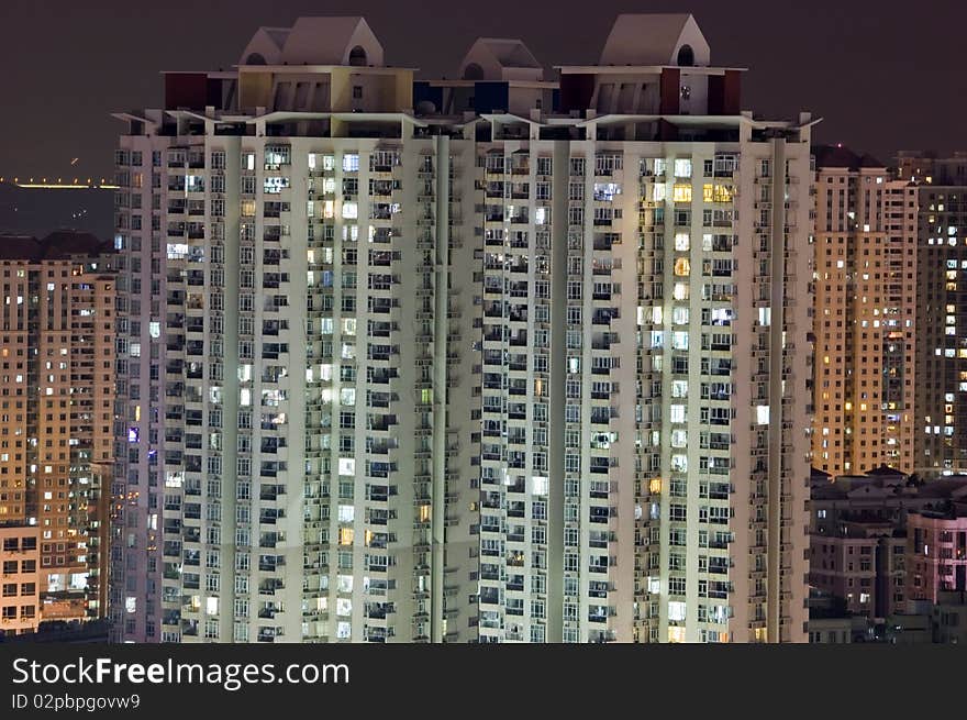 Residential buildings by night, tall skyscrapers in Shenzhen city, China. City with population over 12 millions.