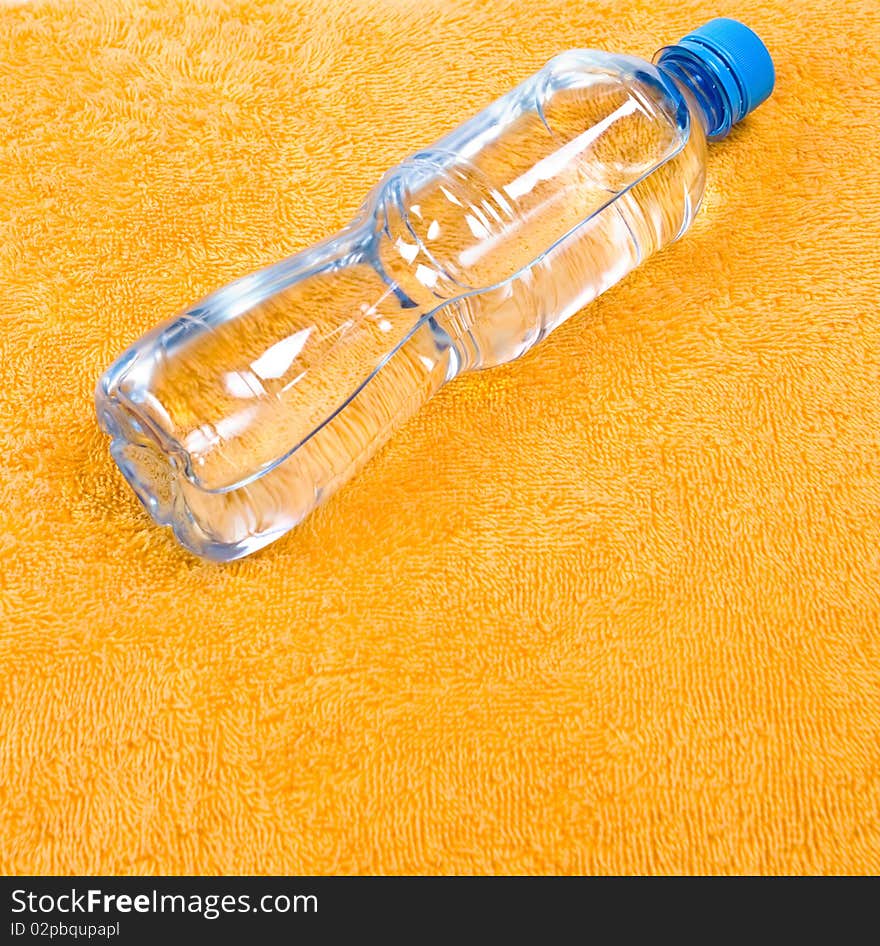 Water in bottle on orange towel