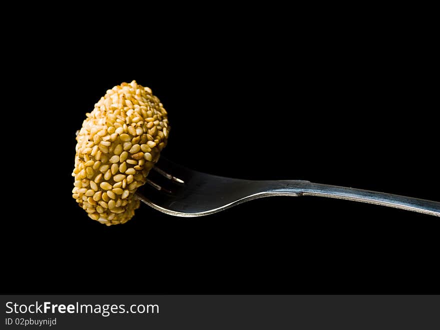 Sweet on a fork isolated on black background