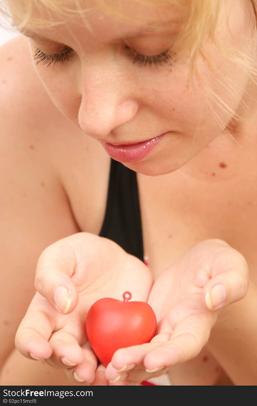 Blond girl holding a heart