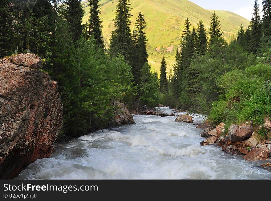 Turgen river and mountainscape amidst vegetation in Turgen vally near Almaty Kazakhstan. Turgen river and mountainscape amidst vegetation in Turgen vally near Almaty Kazakhstan