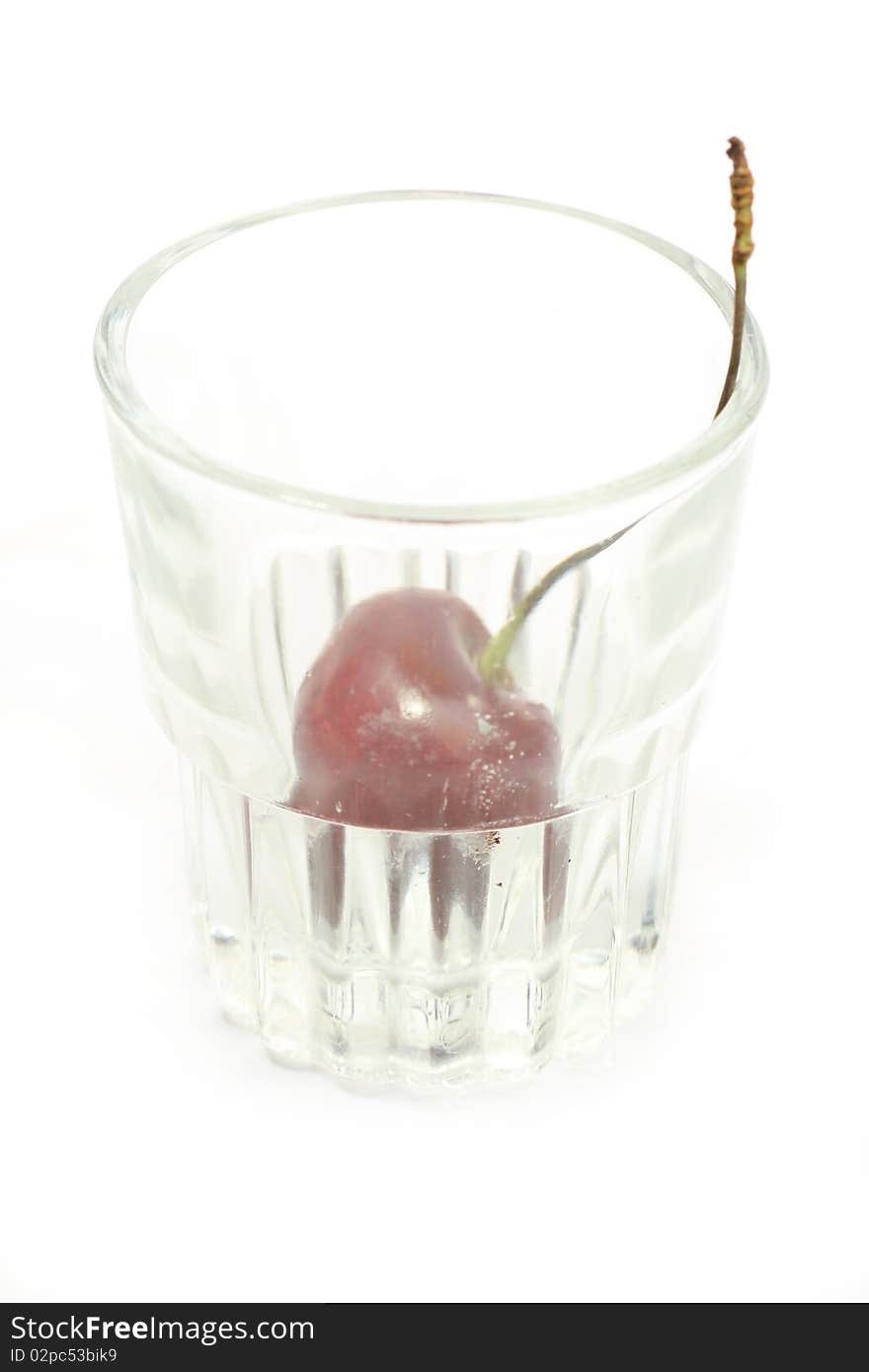 Sweet cherry in a glass over white