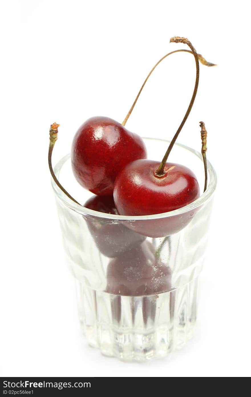 Sweet cherry isolated in a glass over white. Sweet cherry isolated in a glass over white