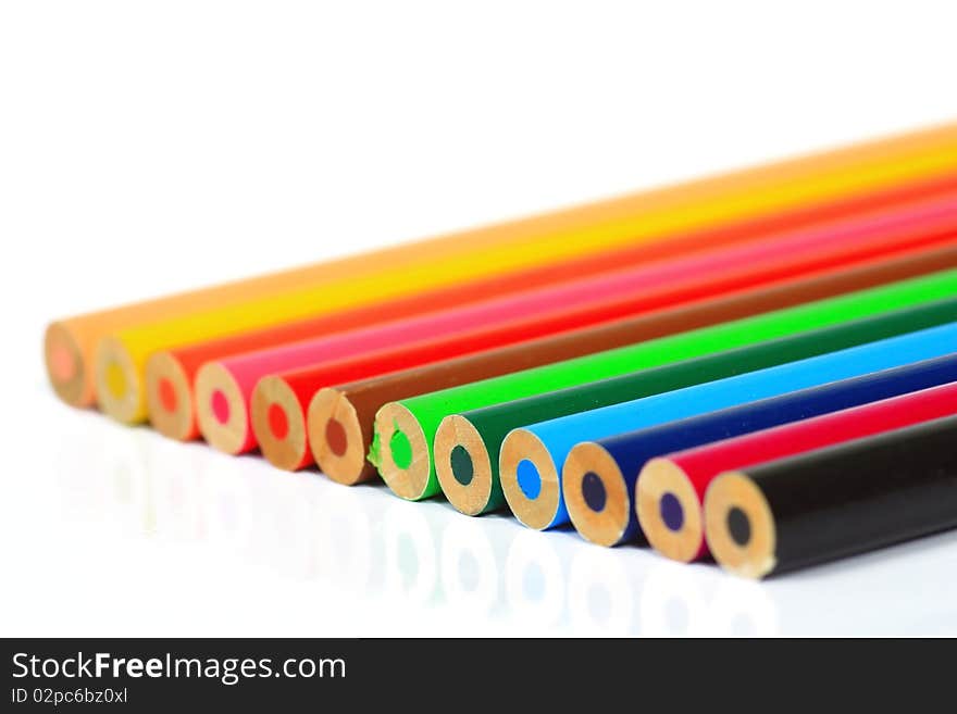 Close up of color pencils with different color over white background.