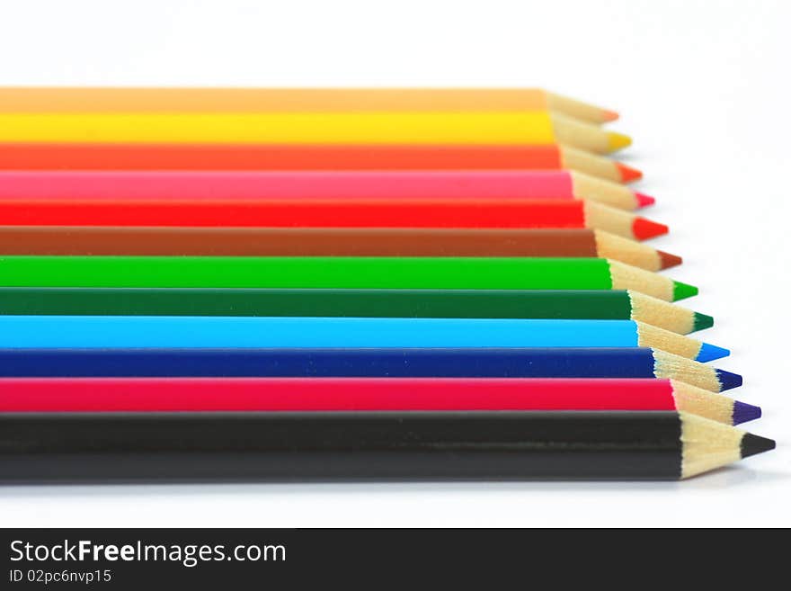 Close up of color pencils with different color over white background.