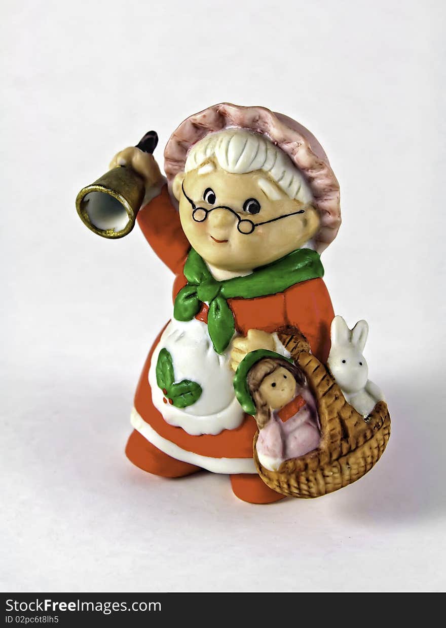 Woman with bell wearing a Christmas dress and carrying a basket. Woman with bell wearing a Christmas dress and carrying a basket.