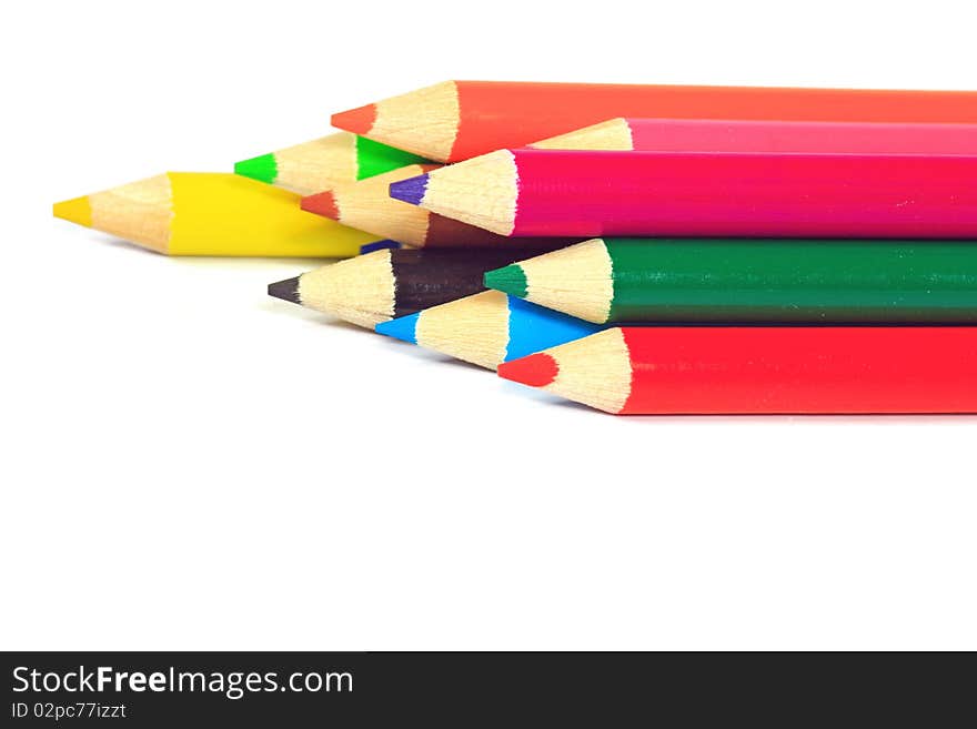 Close up of color pencils with different color over white background.