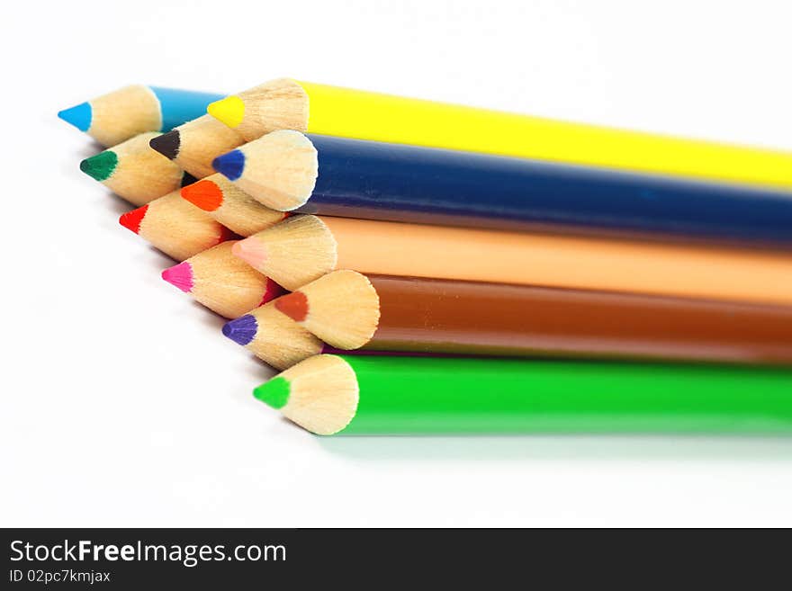 Close up of color pencils with different color over white background.