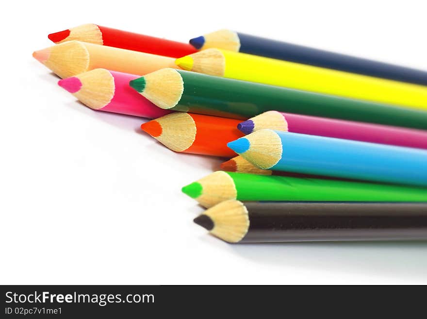 Close up of color pencils with different color over white background.