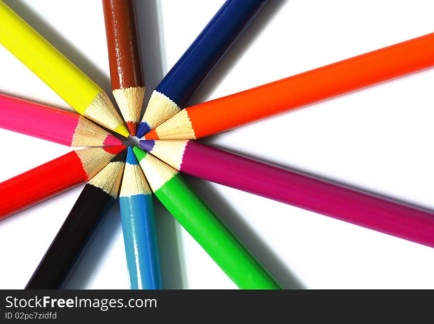 Close up of color pencils with different color over white background.