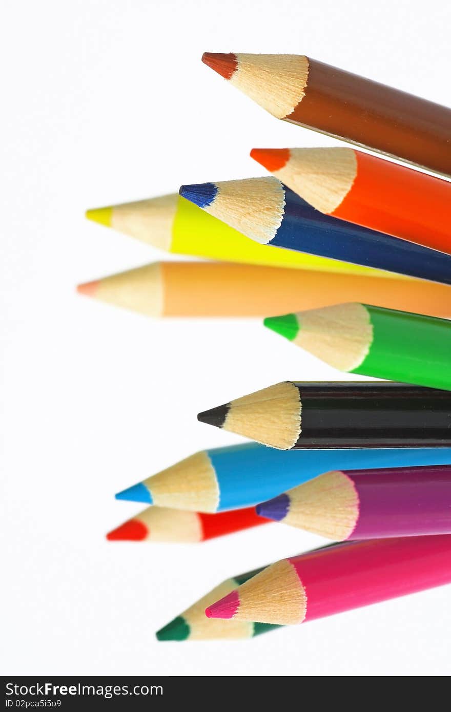 Close up of color pencils with different color over white background.