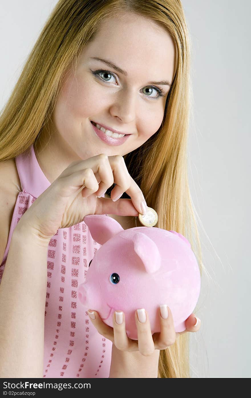 Portrait of woman with a piggy bank