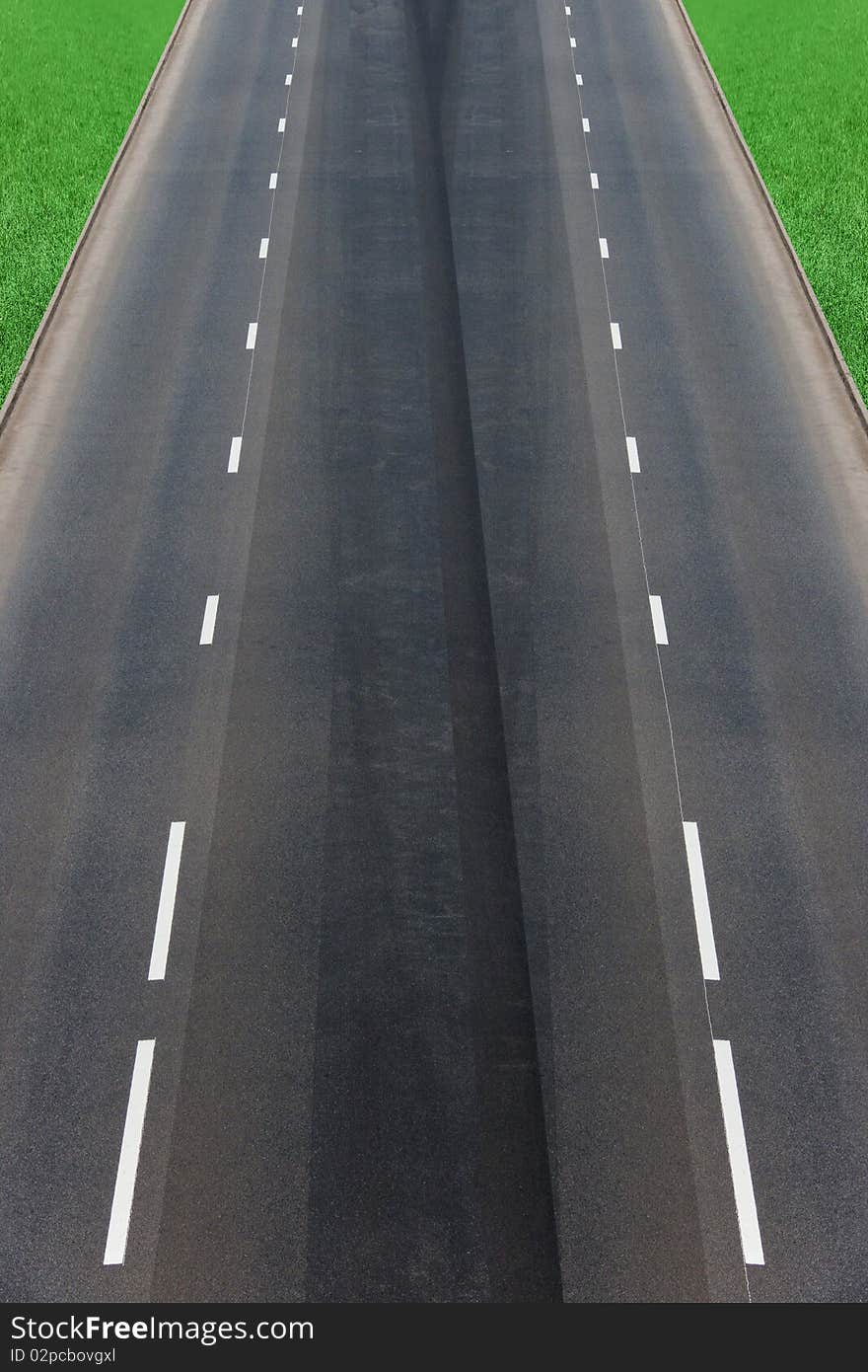 The asphalted road with a green lawn. The asphalted road with a green lawn