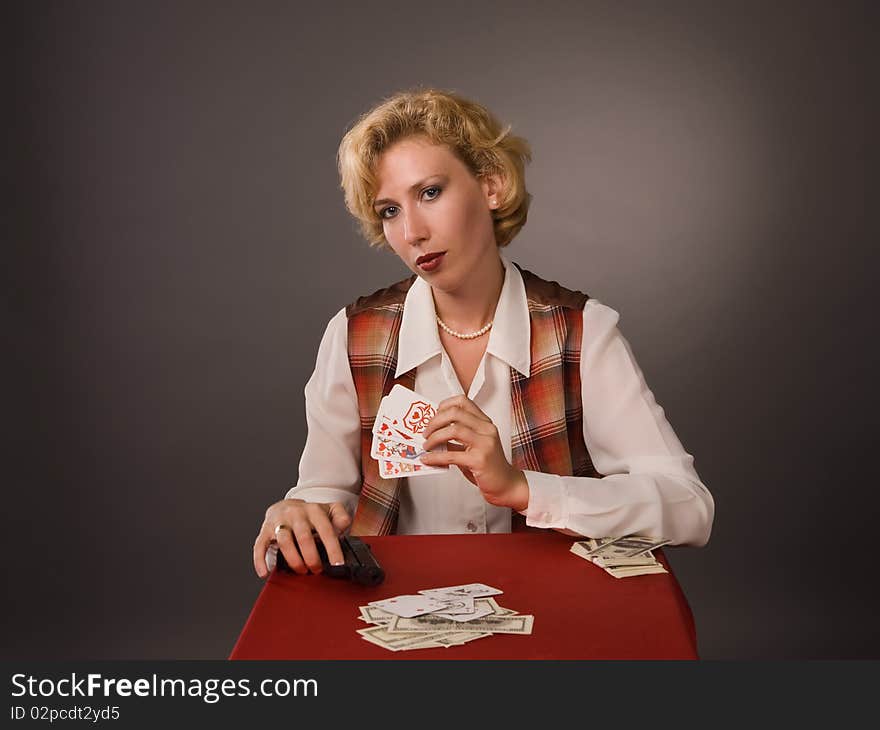 The pretty woman with cards on a grey background