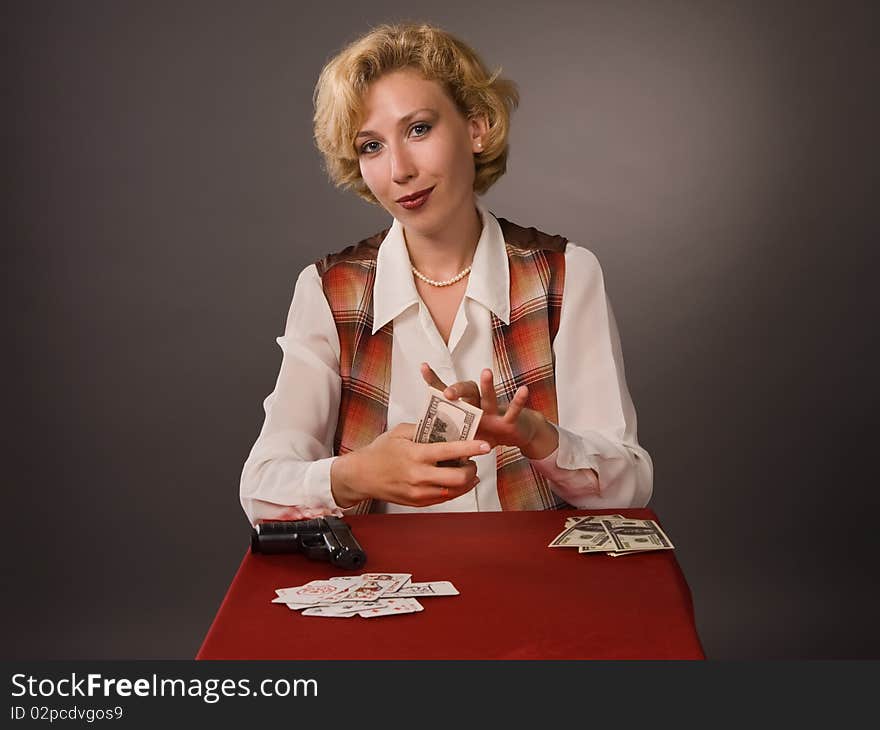 The pretty woman with cards on a grey background