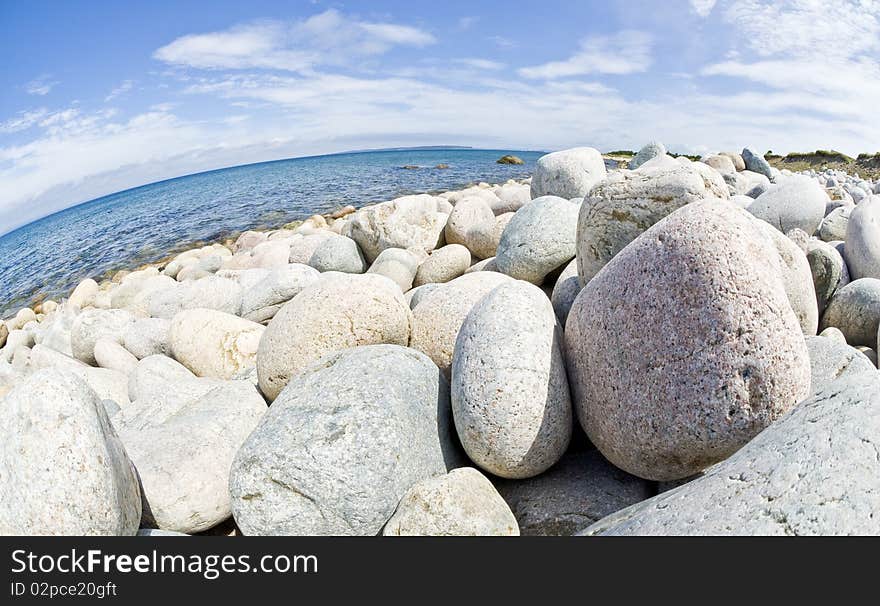 A beach filled with gravels of various sizes. A beach filled with gravels of various sizes.