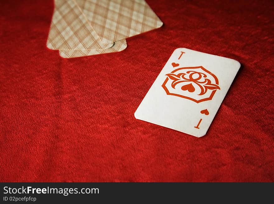 The vintage poker cards on red table