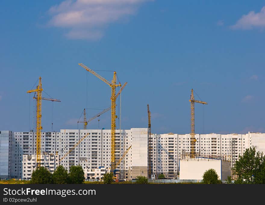 Building of the new high house by the crane. Building of the new high house by the crane