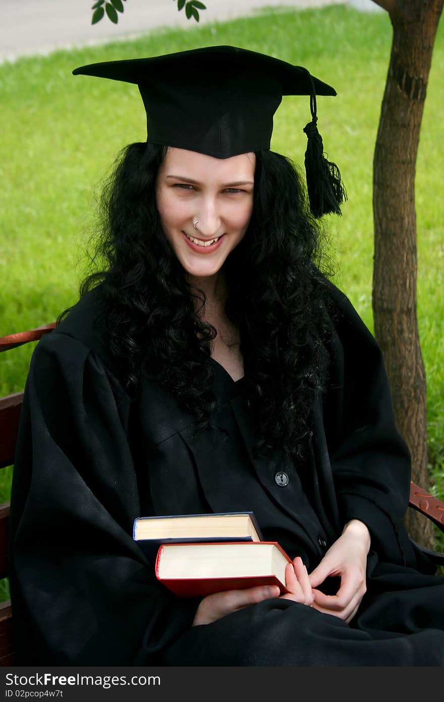 Smiling caucasian student sitting on the bench. Smiling caucasian student sitting on the bench